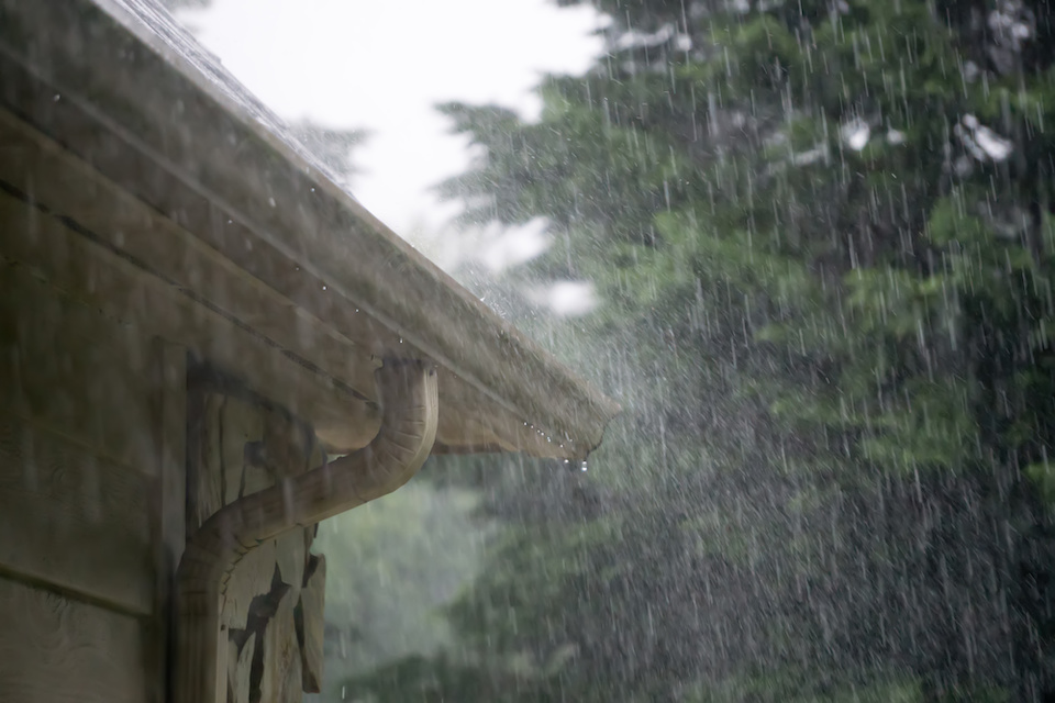 heavy rain pouring down on roof gutters from passing storm; how to install gutters